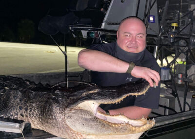 man holding gator mouth open